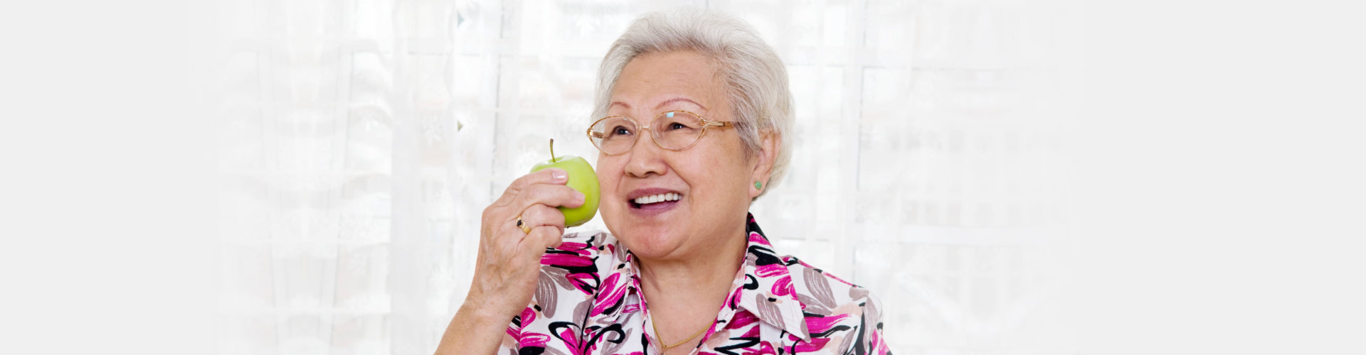 old woman holding the apple